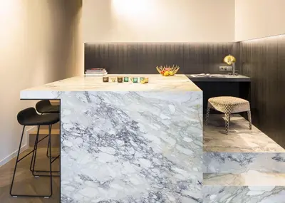 a marble counter with two chairs and a desk at Gulde Schoen Luxury Studio-apartments in Antwerp