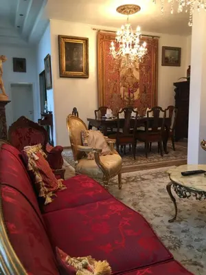 a living room with a red couch and a table at Koetshuis Bosdam in Beveren