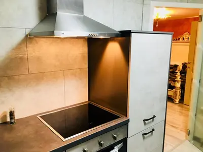 a kitchen with a sink and a stove at Koetshuis Bosdam in Beveren