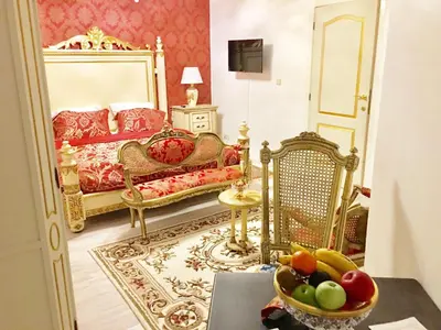 a bedroom with a bed and a bowl of fruit on a table at Koetshuis Bosdam in Beveren