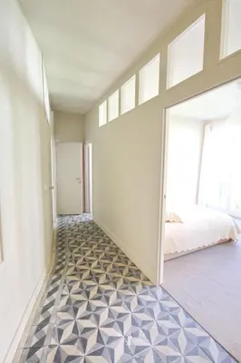 a bedroom with a moroccan tile floor at La maison du fond du jardin in Brussels