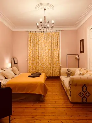 a bedroom with two beds and a chandelier at Bijou Brussels > Parvis St Pierre in Brussels