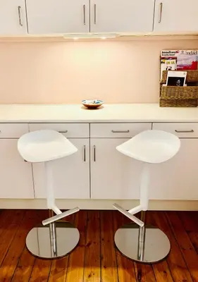 two white stools in front of a kitchen counter at Bijou Brussels > Parvis St Pierre in Brussels