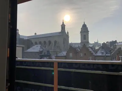 a view of a city from a balcony with the sun setting at Sainte Catherine amazing view in Brussels