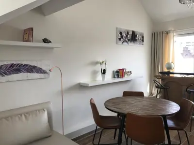 a living room with a table and chairs at Sainte Catherine amazing view in Brussels
