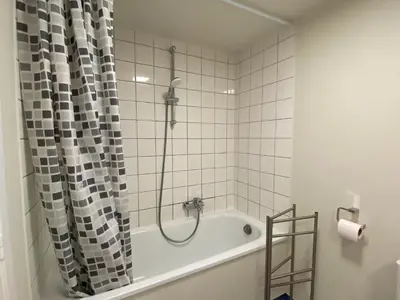 a bathroom with a bath tub with a shower at Sainte Catherine amazing view in Brussels