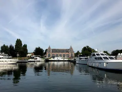 a group of boats docked in front of a building at B&B Tolkantoor in Zelzate