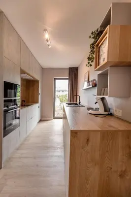 a kitchen with a wooden counter top in a room at Abalona Hotel & Apartments in Dendermonde