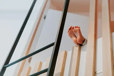 a persons hand is on the edge of a ladder at Hotel Jerom in Kalmthout