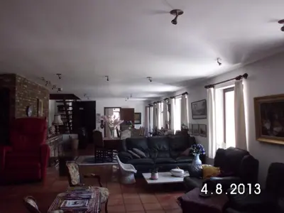 a living room with a couch and a table at 't Vliethuys in Zwijndrecht