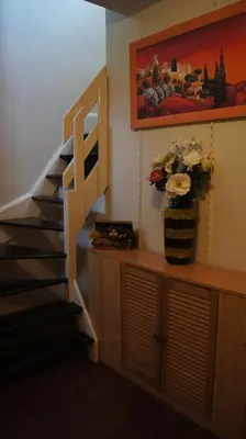 a staircase in a room with a vase of flowers at B&B La Villa Zarin in Brussels