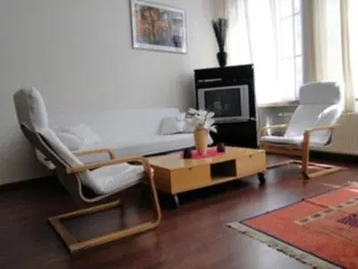 a living room with two chairs and a coffee table at B&B La Villa Zarin in Brussels