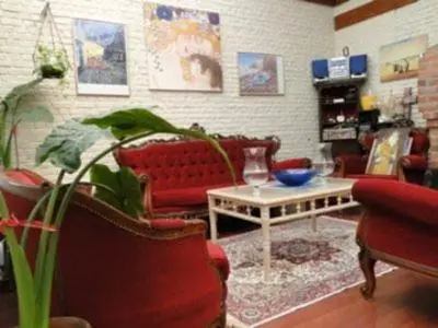 a living room with red couches and a table at B&B La Villa Zarin in Brussels