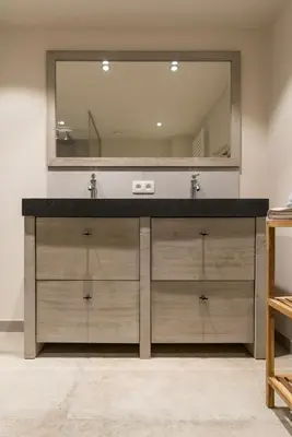 a bathroom with a sink and a large mirror at B&B De Windheer in Sint-Martens-Lennik