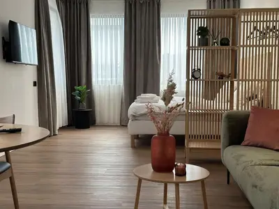 a living room with a couch and a table at Hotel Arriate in Lochristi