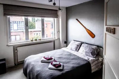 a bedroom with a bed with two towels on it at B&B 1 uit de 100 in Ghent