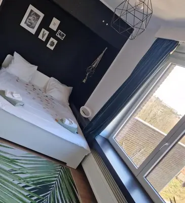a bedroom with a bed and a window at B&B 1 uit de 100 in Ghent