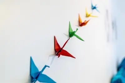 a group of origami airplanes flying in the sky at B&B 1 uit de 100 in Ghent