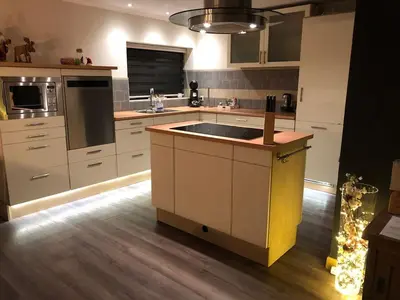 a kitchen with a sink and a counter top at Luxe vakantiehuis in het bos in Overbroek