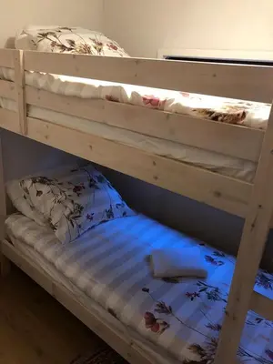 a couple of bunk beds in a room at Luxe vakantiehuis in het bos in Overbroek