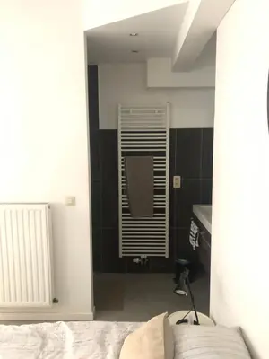 a bedroom with black and white walls and a window at B&B Loft Jamar Gare Du Midi in Brussels