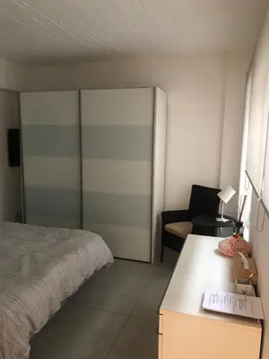 a bedroom with a bed and a desk and a chair at B&B Loft Jamar Gare Du Midi in Brussels
