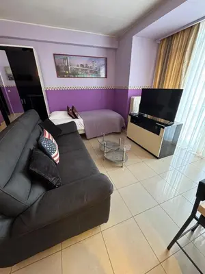 a living room with a couch and a piano at Aparthotel Résidence Bara Midi in Brussels