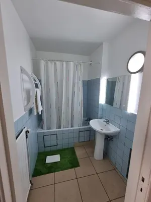 a bathroom with a sink and a shower curtain at Aparthotel Résidence Bara Midi in Brussels