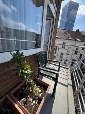 a chair sitting on a balcony with a window at Aparthotel Résidence Bara Midi in Brussels