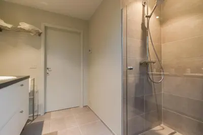 a bathroom with a shower with a glass door at Clayshoeve in Munte