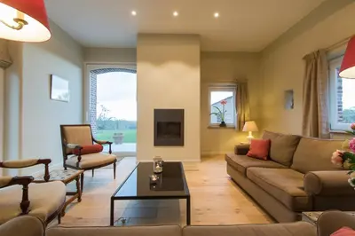 a living room with a couch and a table at Clayshoeve in Munte