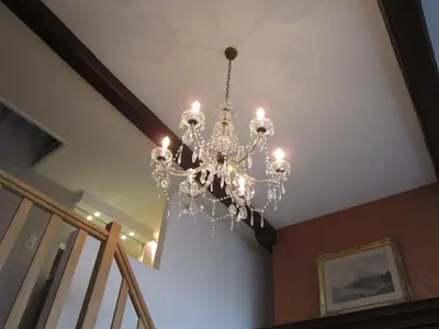 a chandelier hanging from a ceiling in a house at Geldmunt Apartment in Ghent
