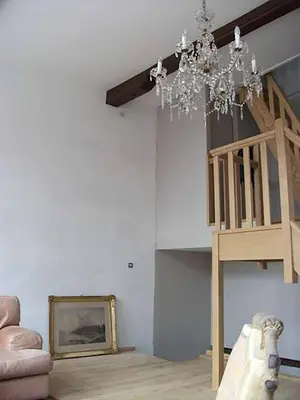 a living room with a chandelier hanging from the ceiling at Geldmunt Apartment in Ghent