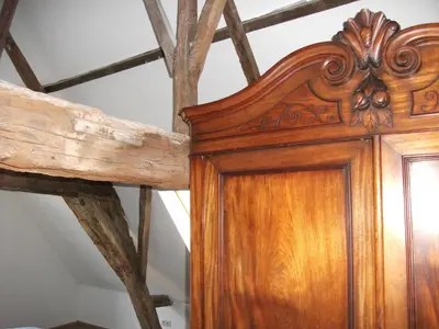 a wooden door in a room with a ceiling at Geldmunt Apartment in Ghent