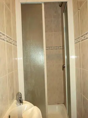a bathroom with a shower and a sink and a toilet at Hotel Continental Gare du Midi in Brussels