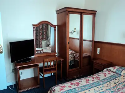 a hotel room with a desk and a mirror at Hotel Continental Gare du Midi in Brussels