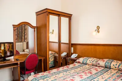 a hotel room with a bed and a desk at Hotel Continental Gare du Midi in Brussels