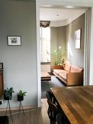 a living room with a table and a couch at Domus Portus in Dendermonde