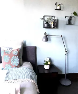 a bedroom with a bed and a desk with a lamp at Domus Portus in Dendermonde