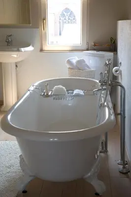 a white bath tub in a bathroom with a sink at Domus Portus in Dendermonde