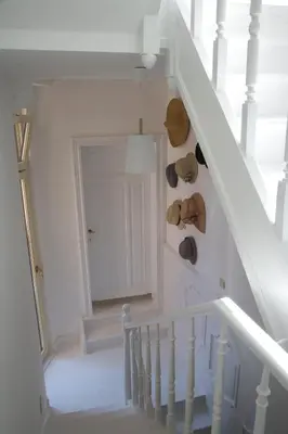 a white staircase with a teddy bear on the wall at Domus Portus in Dendermonde
