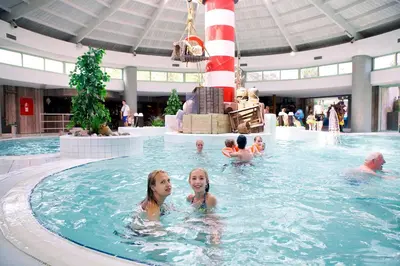 a group of people swimming in a swimming pool at EuroParcs Zilverstrand in Mol