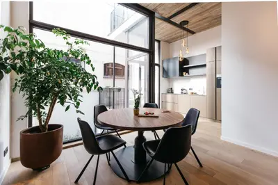 a dining room with a table and chairs and a potted plant at Charlie's Bed & Breakfast in Antwerp