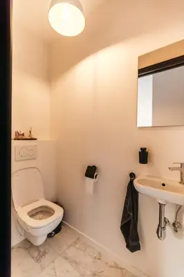 a bathroom with a toilet and a sink at Charlie's Bed & Breakfast in Antwerp
