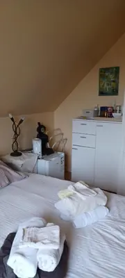 a bedroom with a bed with towels on it at didi logement in Westerlo
