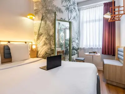 a hotel room with a bed with a laptop on it at Hotel Siru Brussels in Brussels