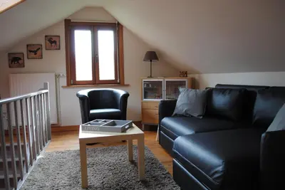 a living room with a couch and a table at 't Huizeke in Asse