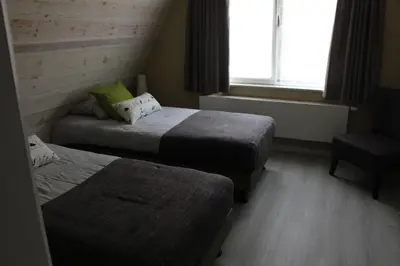 a hotel room with two beds and a window at Saffels Nest in Lochristi