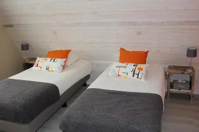 two beds sitting next to each other in a room at Saffels Nest in Lochristi