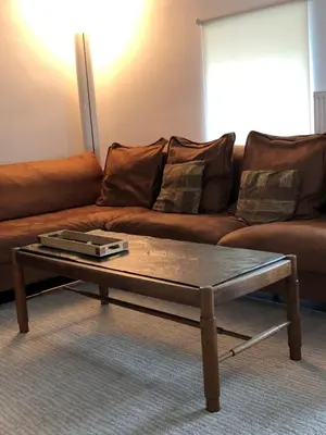 a coffee table in front of a brown couch at Constantinus in Herzele